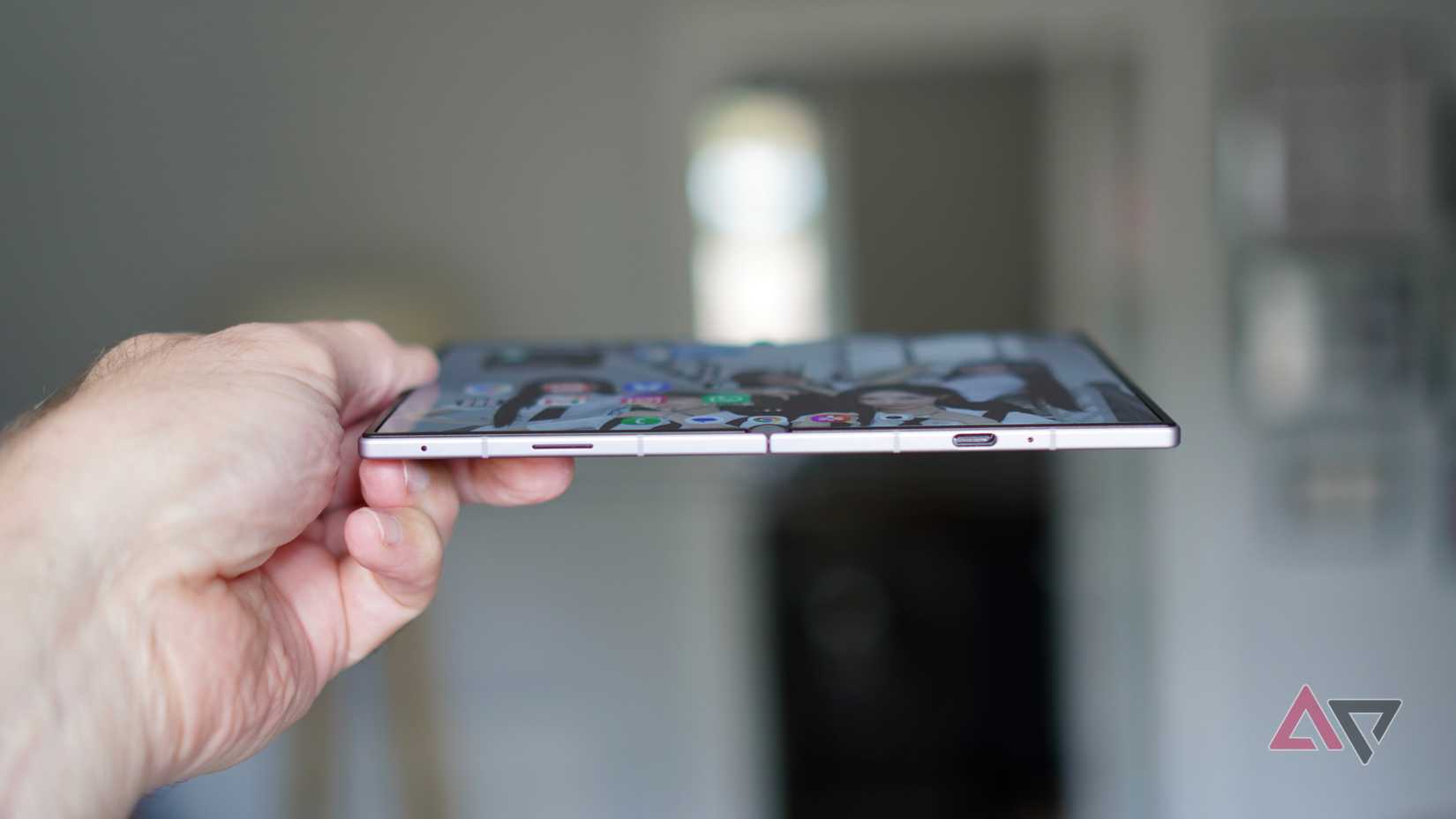 A person holding the open Samsung Galaxy Z Fold 8