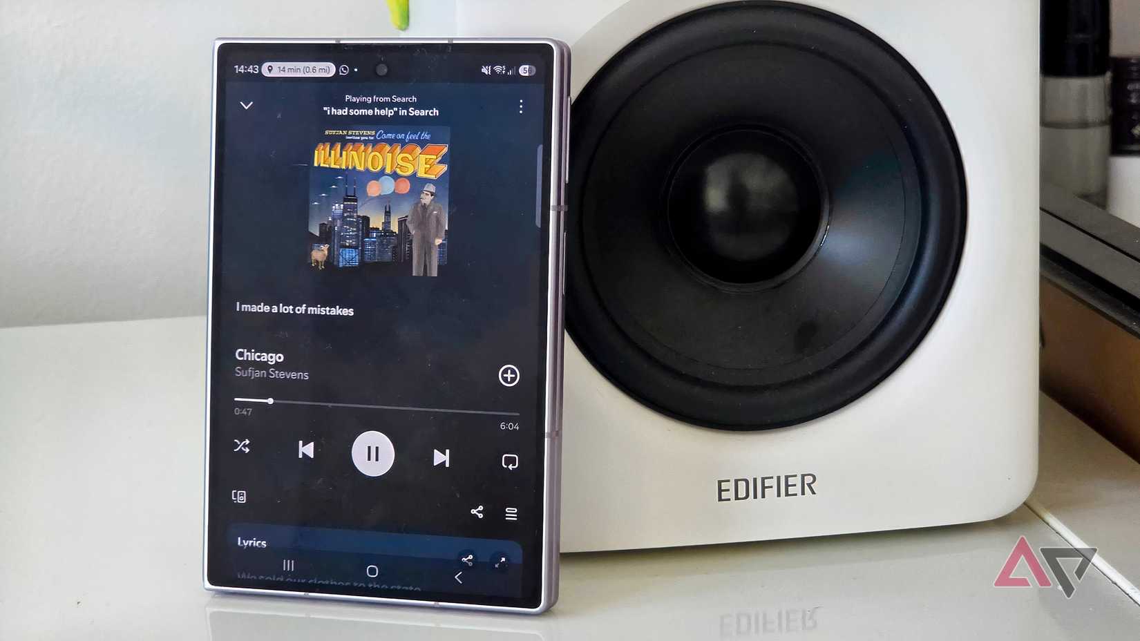 The Samsung Galaxy Z Fold 8 leaning on a speaker, playing from Spotify.