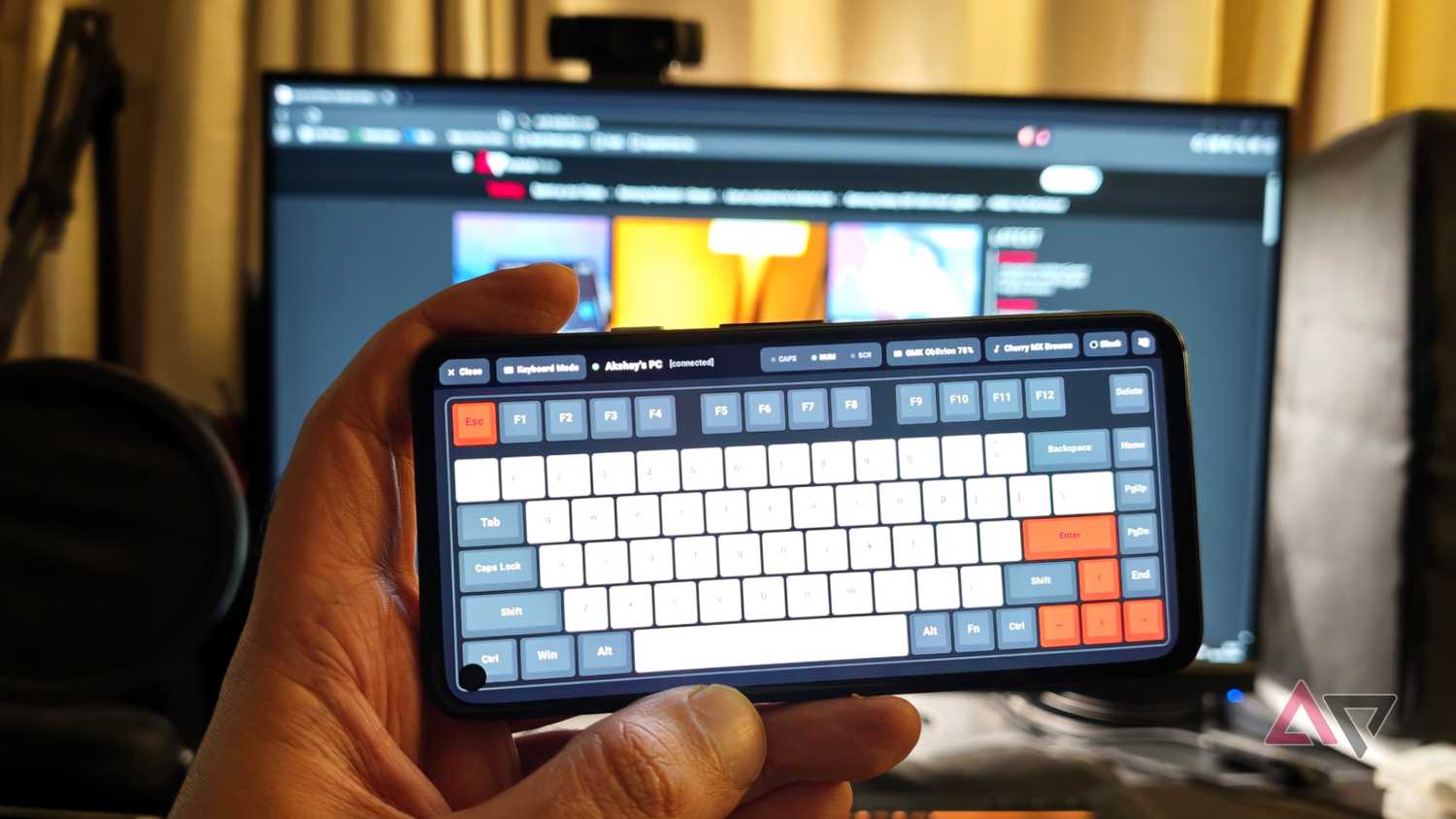 Bluke app running on a GMK oblivion keyword on the Pixel 4a with a PC in the background