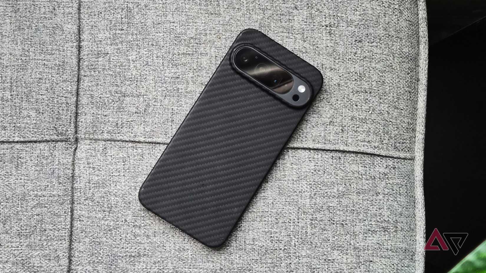 Google-Pixel-camera-phone-with-carbon-fiber-case-on-a-couch
