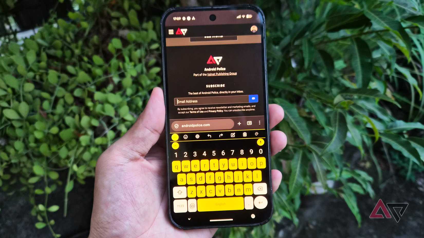Google Pixel 9 Pro XL phone with FUTO keyboard app in high-contrast yellow