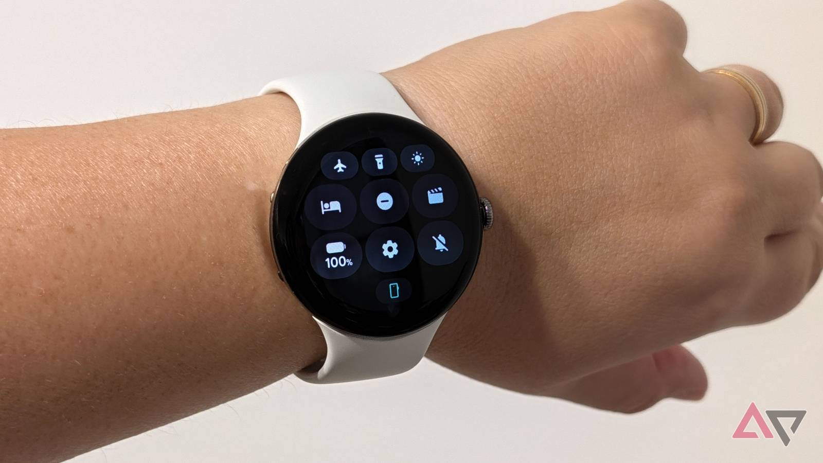 Quick Settings showing 100% battery on the Pixel Watch 5, on a wrist