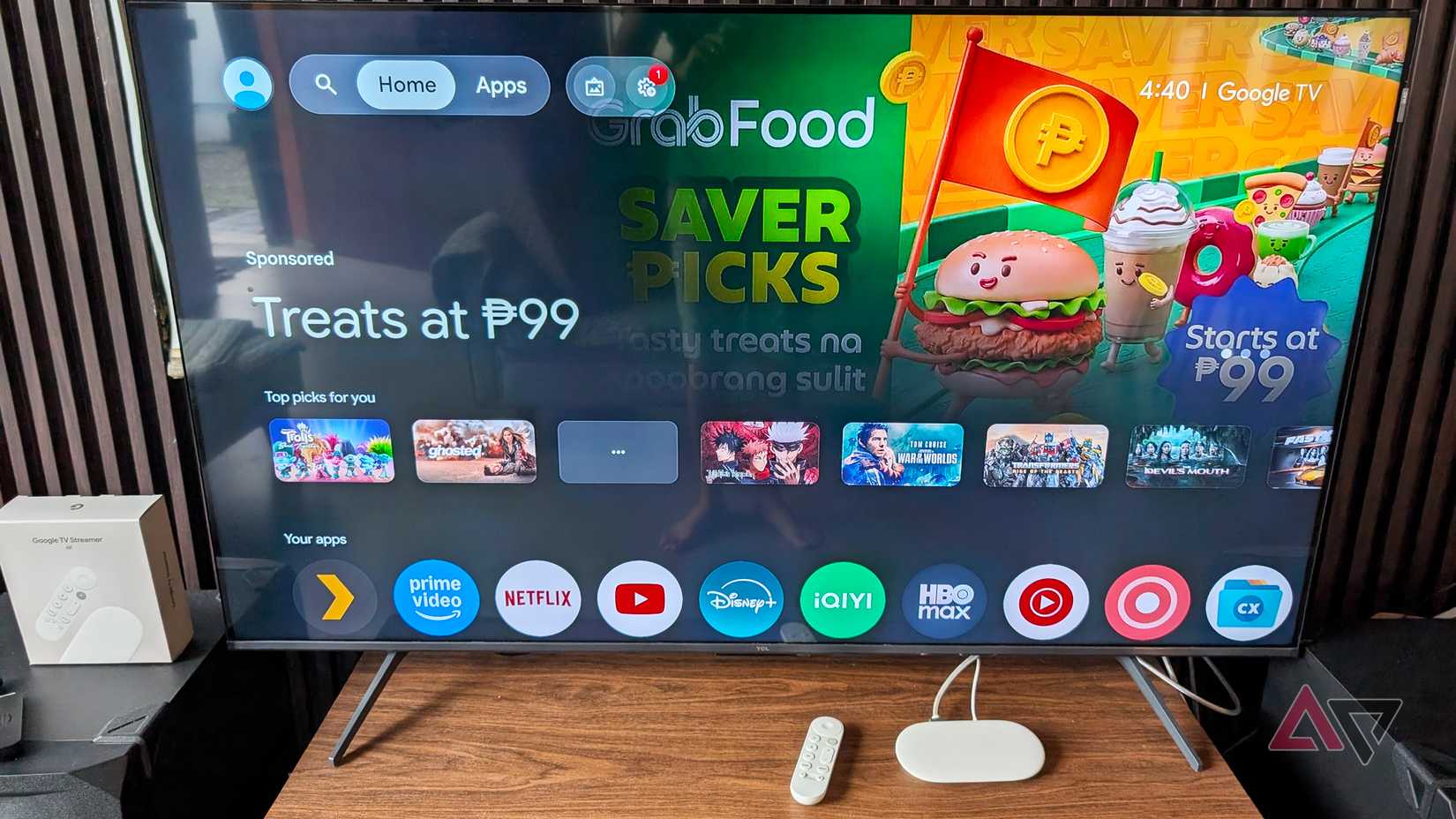 Google TV Streamer and Remote on a desk with a TCL TV behind