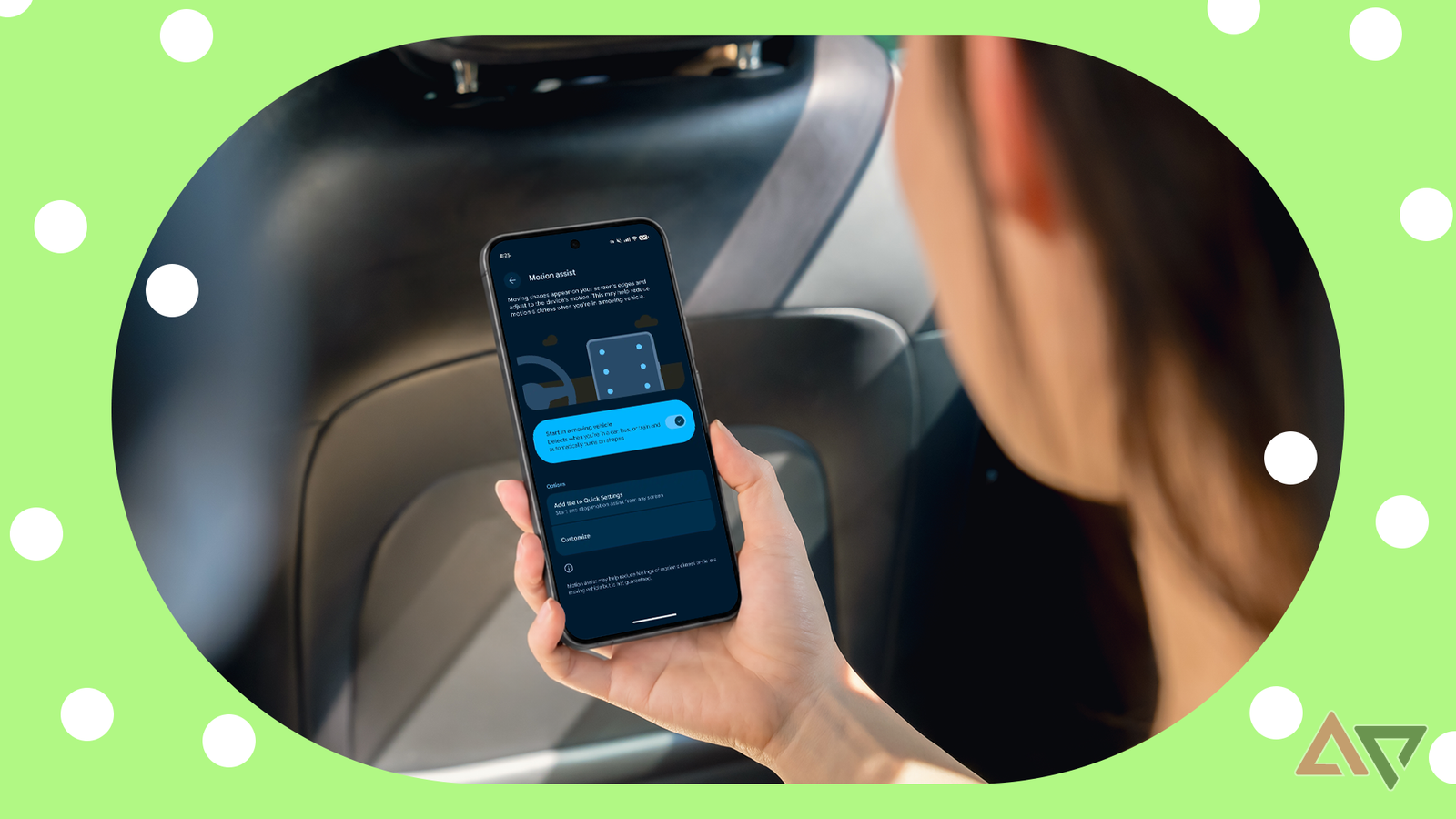 Person holding an Android phone with Motion Assist enabled inside a moving car.