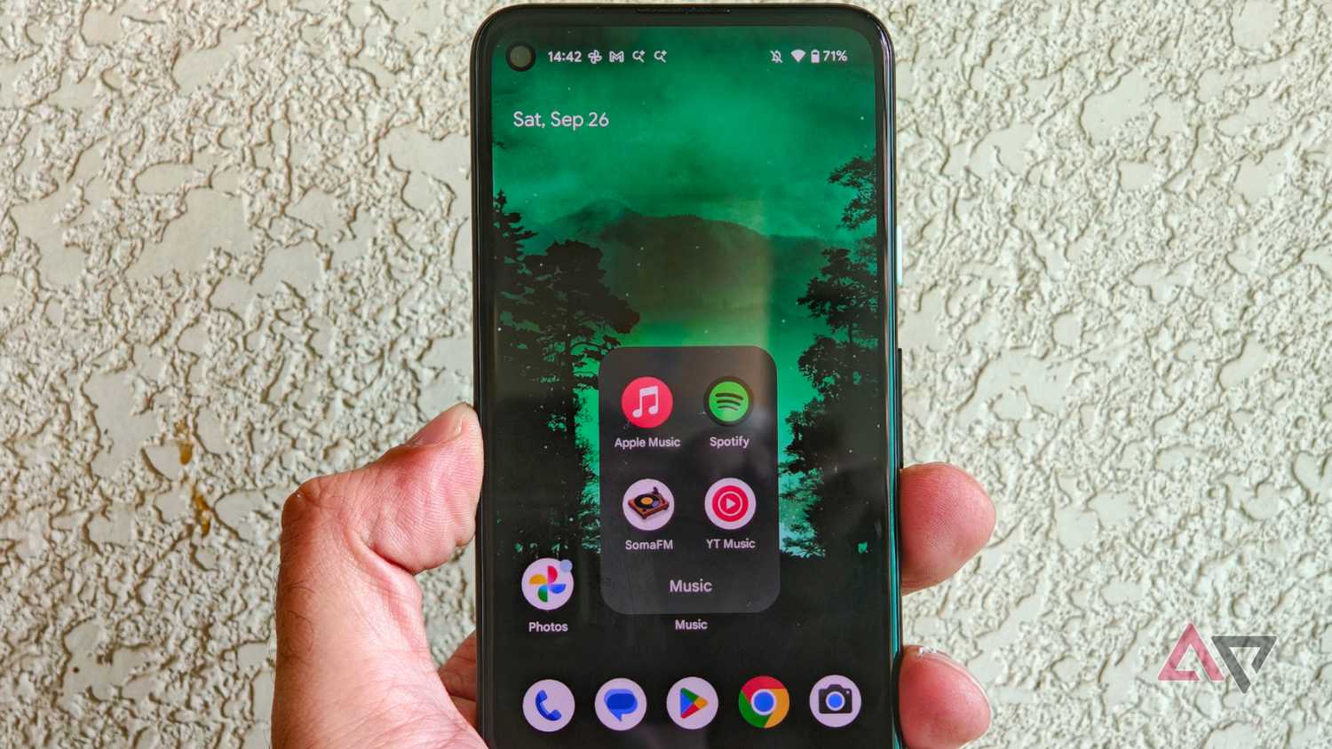 A Pixel 4a in hand with the music folder open showing streaming apps