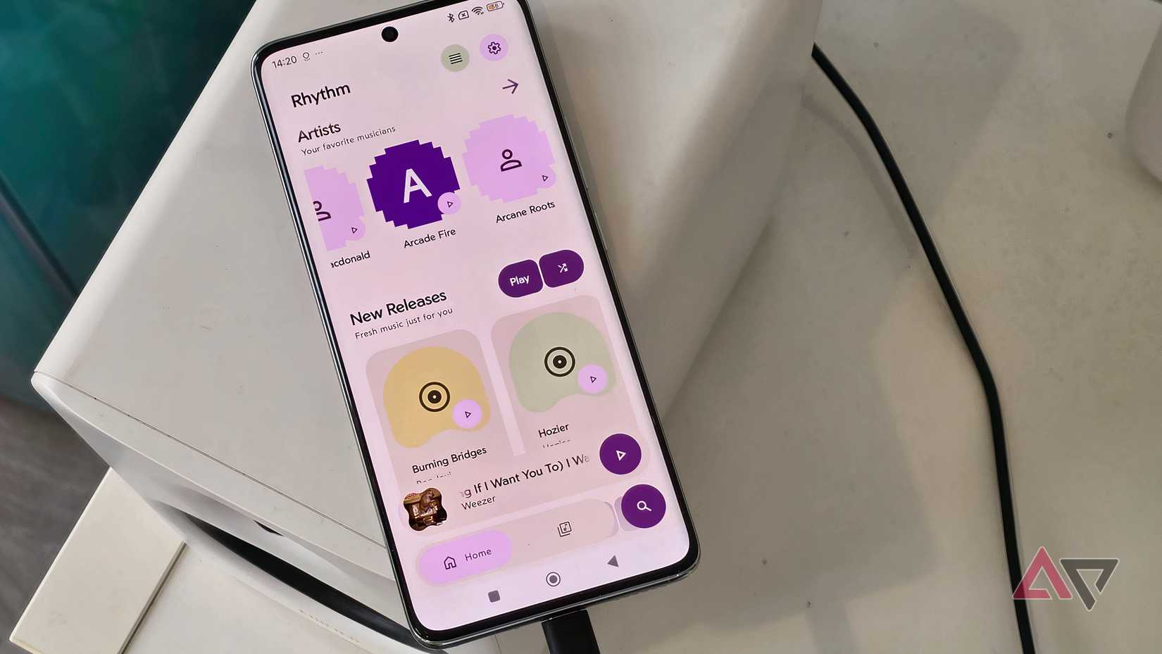A Poco X7 plugged into an Edifier M90, showing the Rhythm app with the home page displayed.