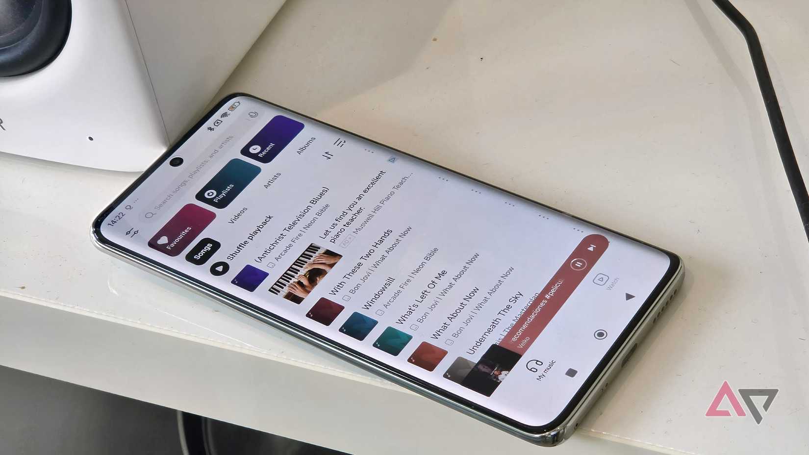 A Poco X7 plugged into an Edifier M90, showing the default music player app.