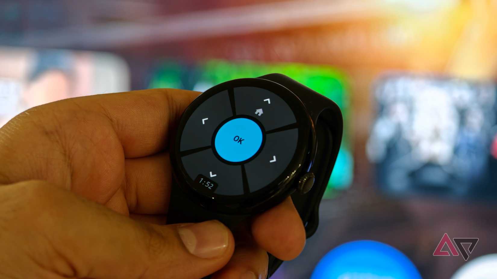 Google Pixel Watch showing the Remote for Android TV interface with directional controls and a central OK button