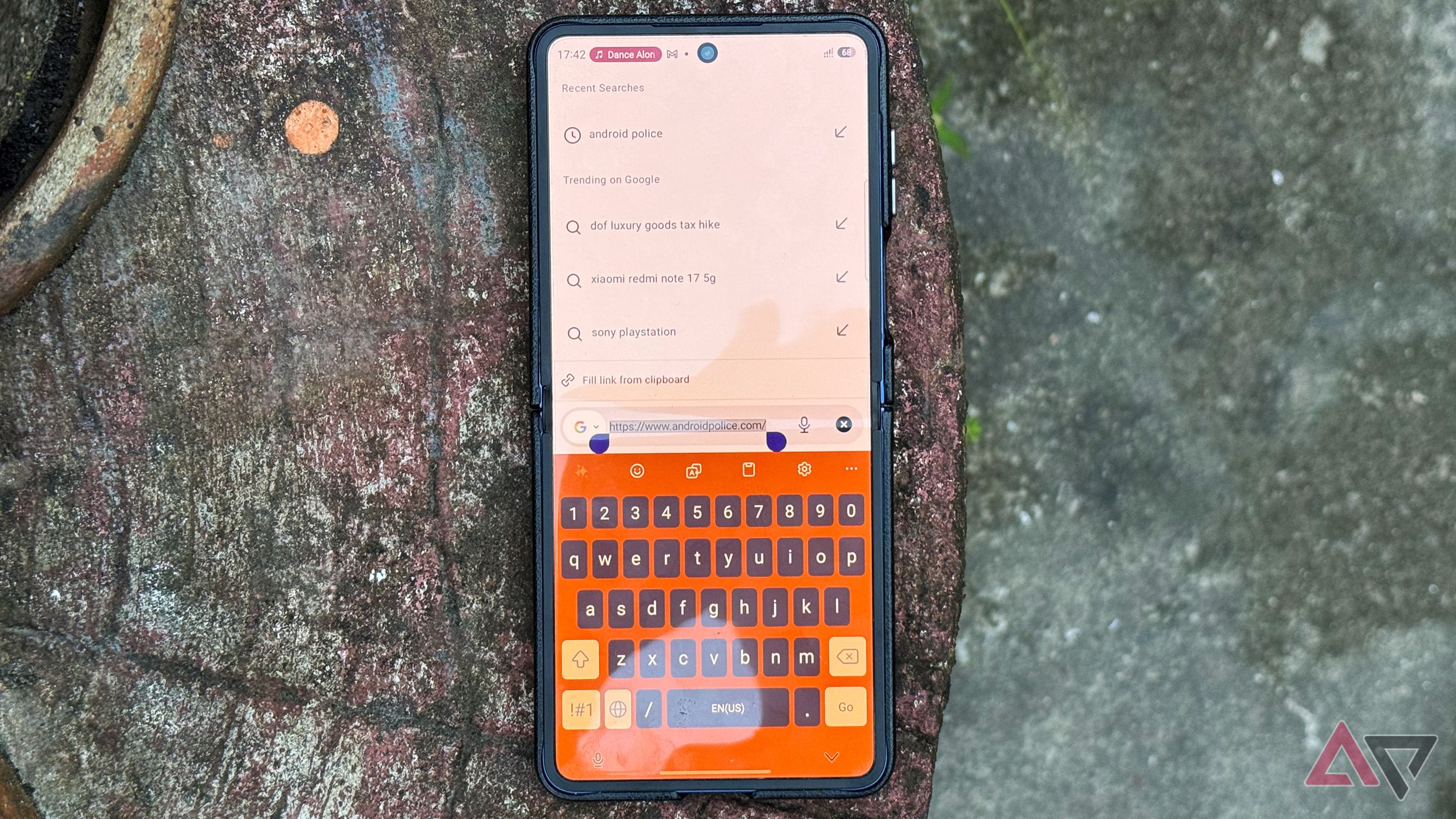 Samsung Galaxy Z Flip 7 smartphone with Google search and Keyboard app
