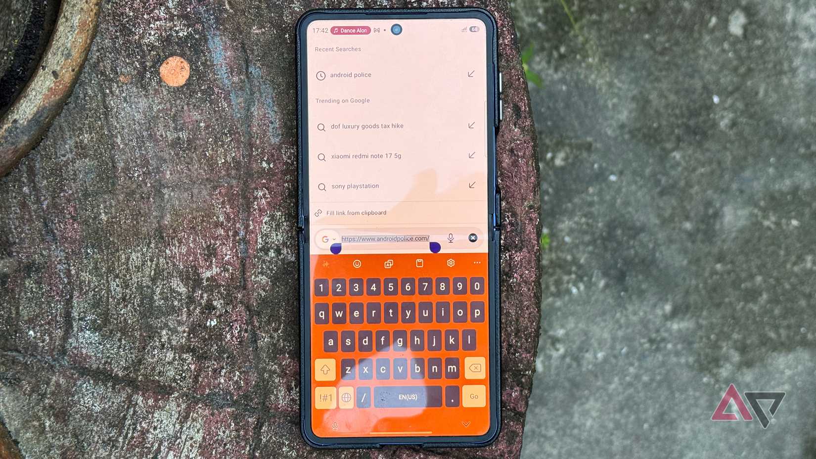 Samsung Galaxy Z Flip 7 smartphone with Google search and Keyboard app