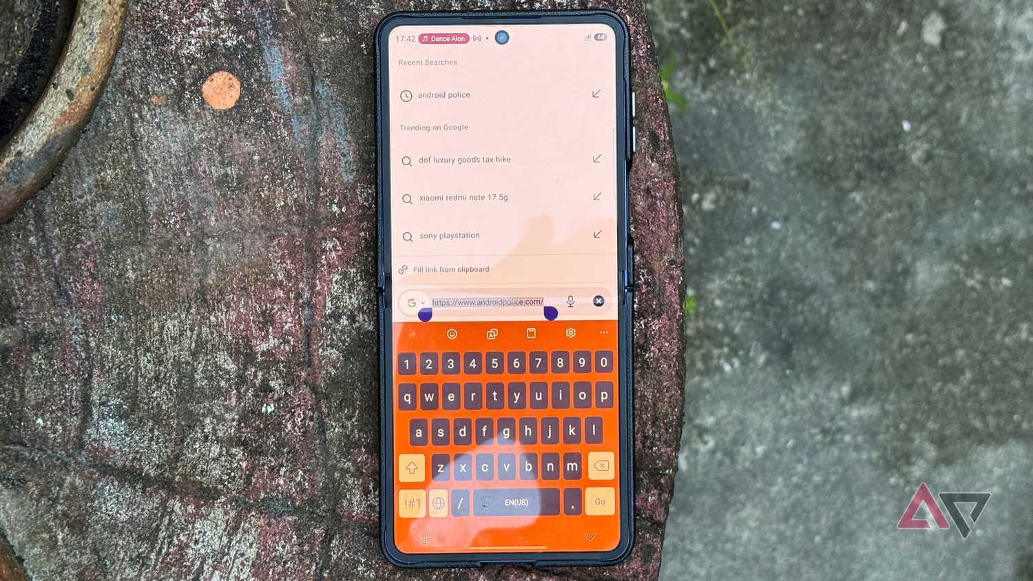 Samsung Galaxy Z Flip 7 smartphone with Google search and Keyboard app
