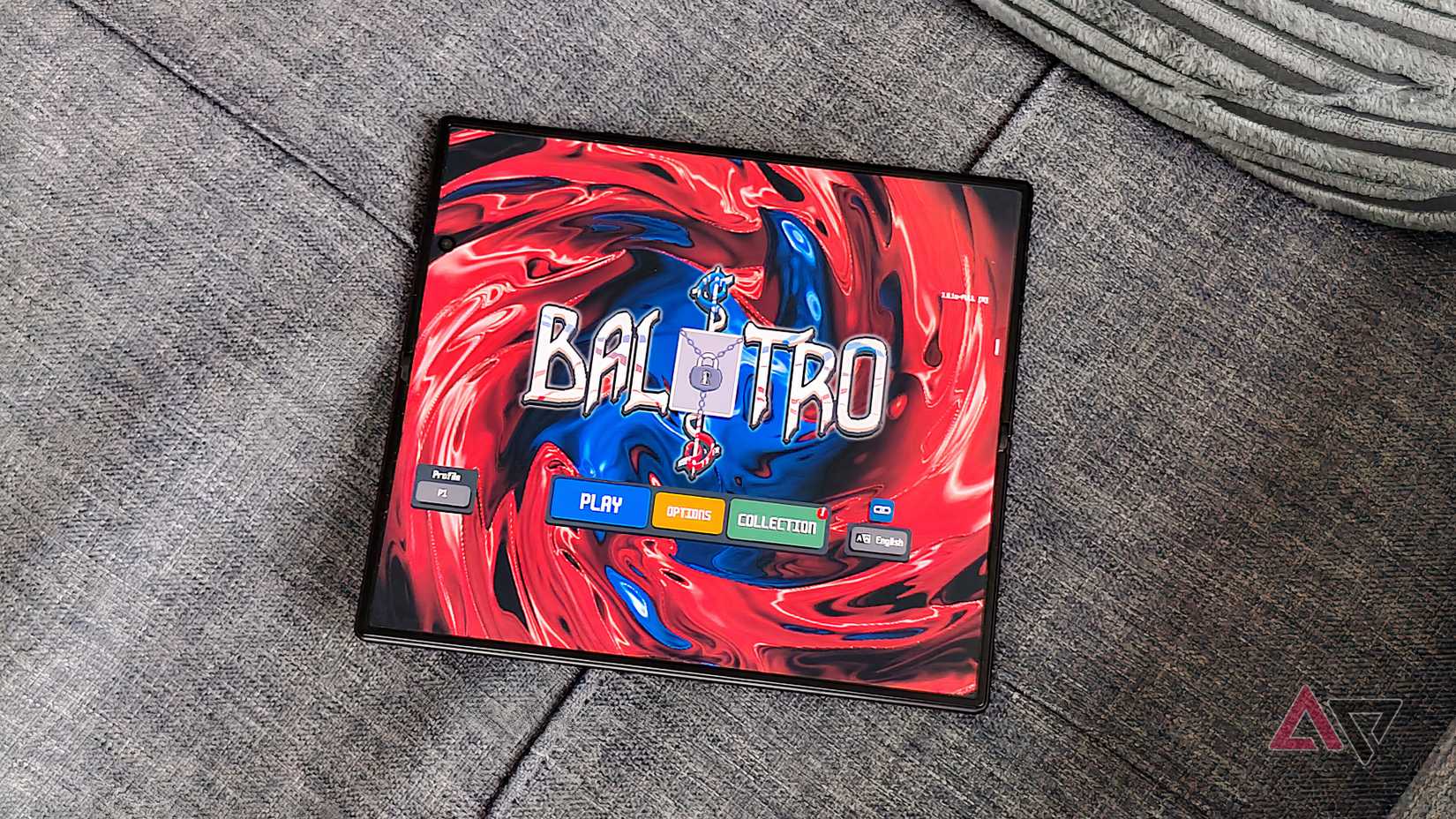 The Samsung Galaxy Z Fold 8 unfolded on a sofa, showing Balatro.