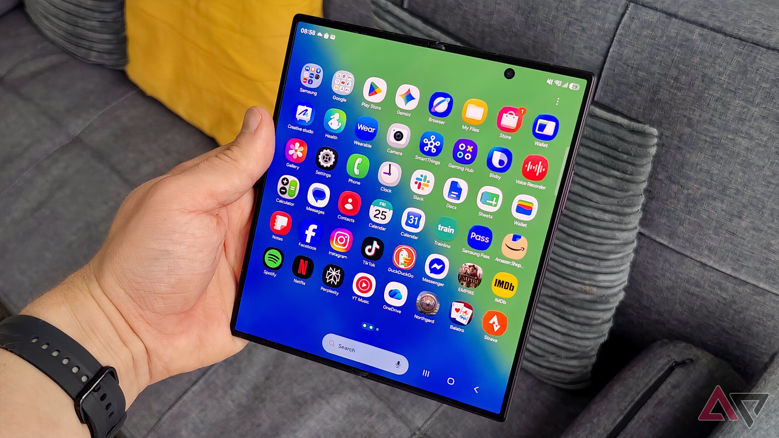 The Samsung Galaxy Z Fold 8, unfolded in a man's hand, showing plenty of apps.