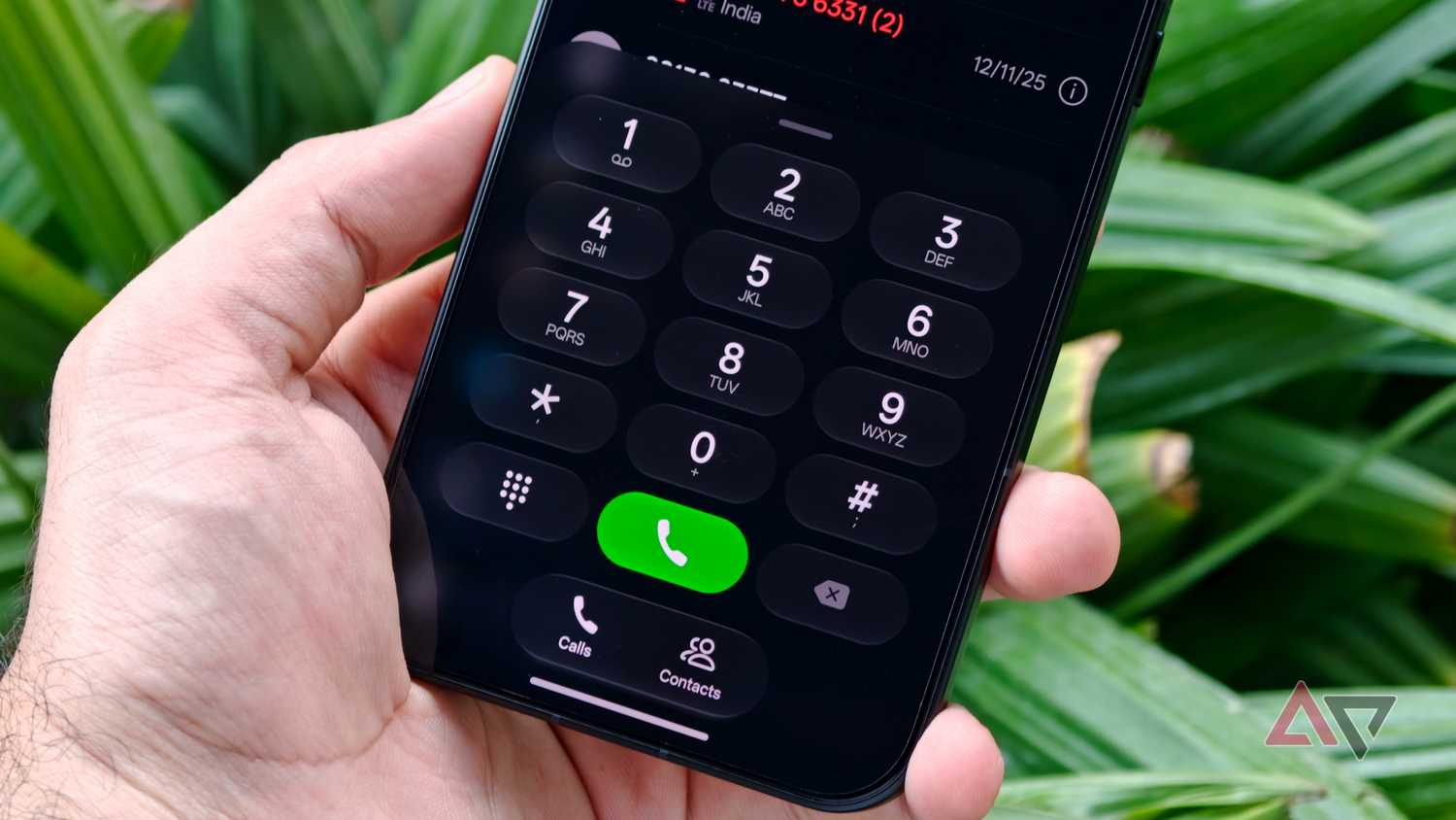 Smartphone hand-held showing ColorOS 17 phone dialer app keypad interface