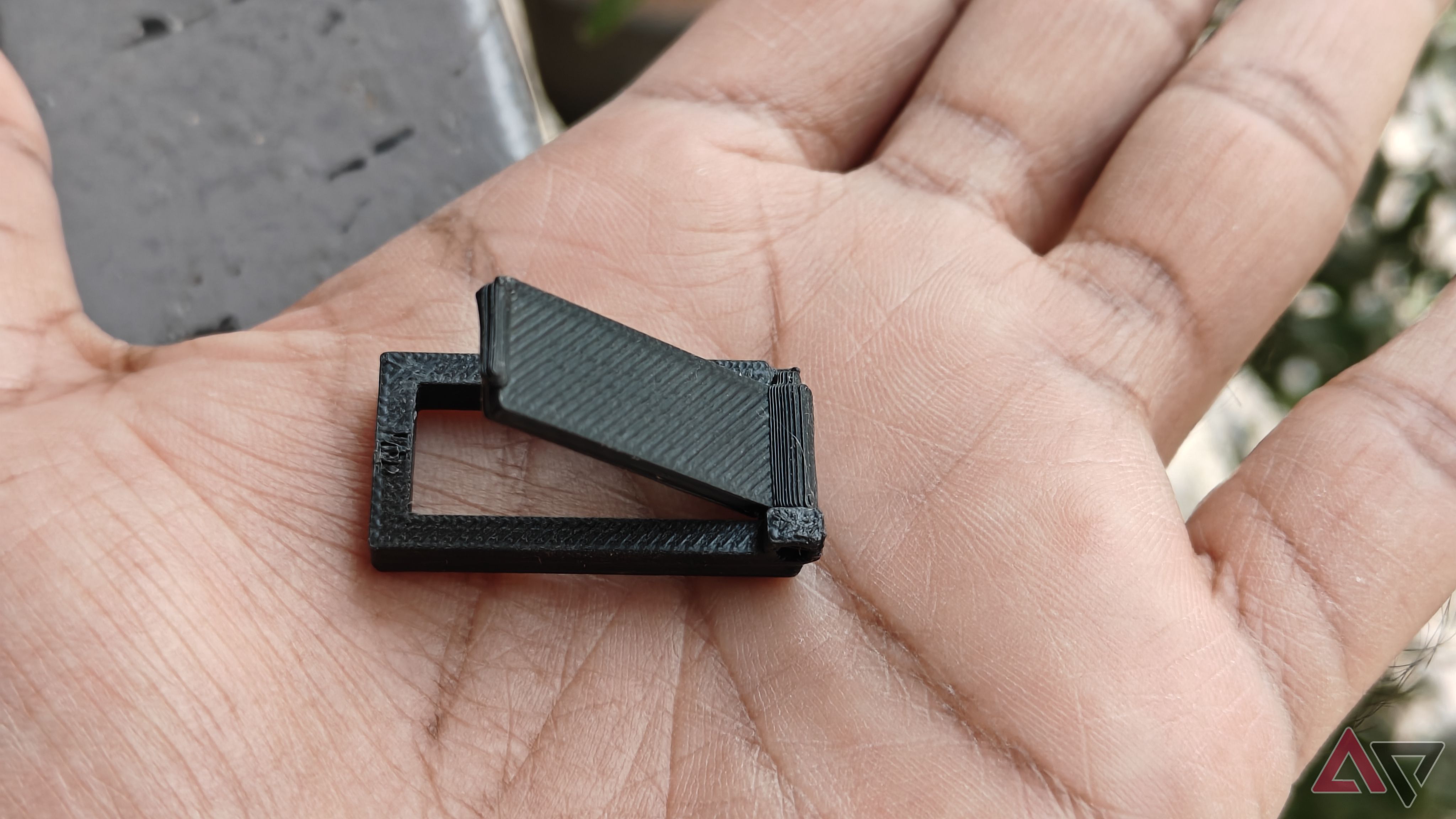 Photo showing the 3D-printed door lock on a hand