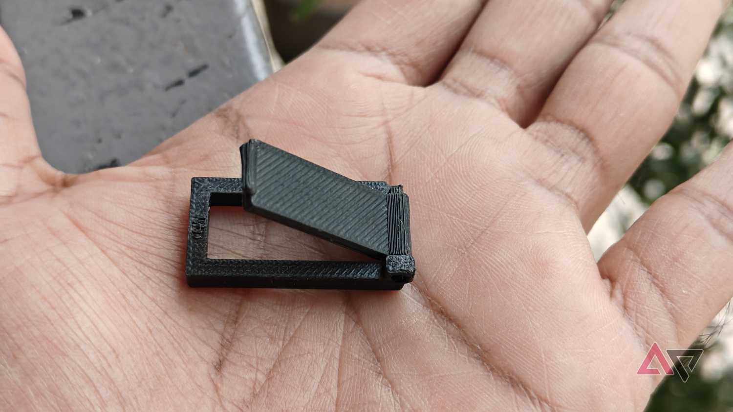 Photo showing the 3D-printed door lock on a hand
