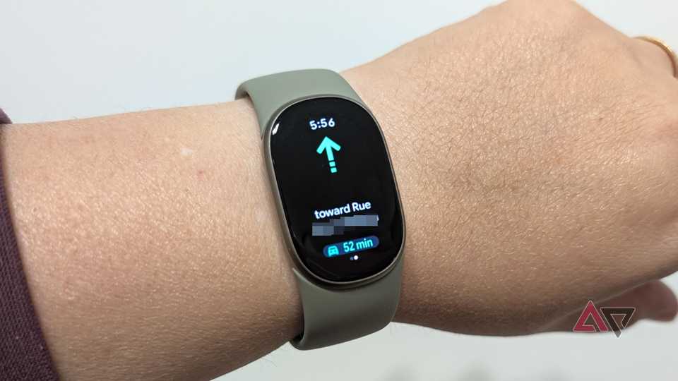 Google Fitbit Edge on a wrist showing Google Maps next direction
