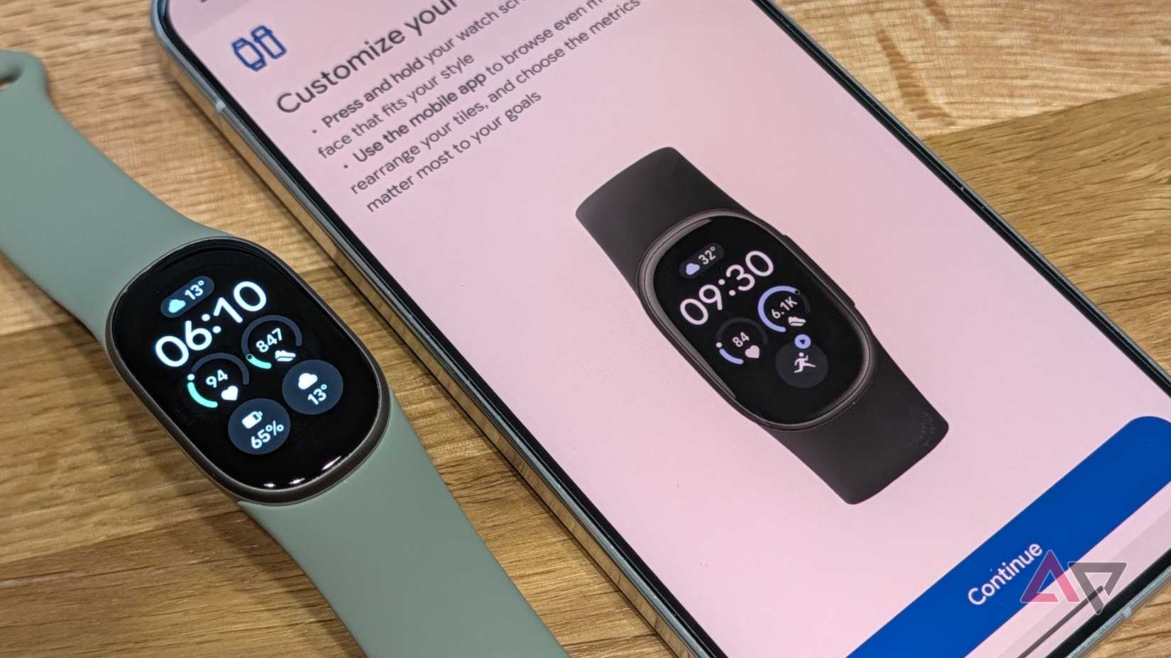 Google Fitbit Edge on a table next to the Google Health watch face customization screen